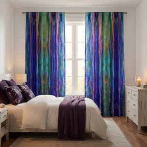 May include: A bedroom scene featuring a bed with white bedding and a purple throw blanket. The focal point is the pair of vibrant, abstract-patterned curtains in shades of blue, green, and purple. A white dresser and nightstand complete the room's decor.