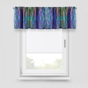 May include: A decorative window valance with a colorful, abstract design. The valance features a mix of blues, greens, and purples, creating a watercolor effect. It is mounted above a white window, adding a pop of color to the room.