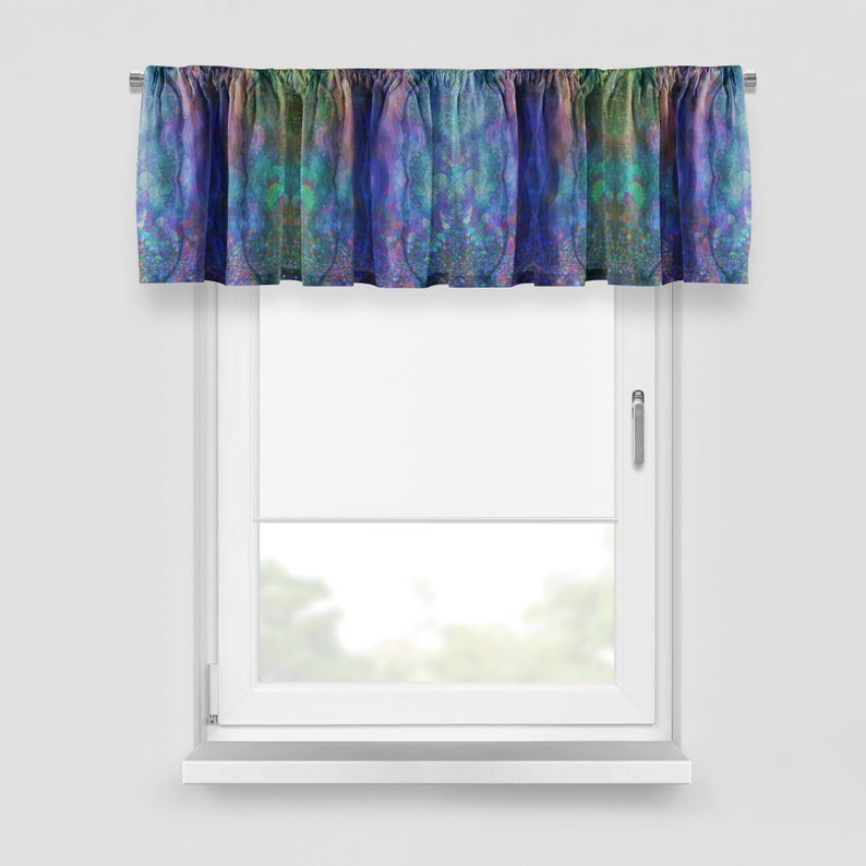 May include: A decorative window valance with a colorful, abstract design. The valance features a mix of blues, greens, and purples, creating a watercolor effect. It is mounted above a white window, adding a pop of color to the room.