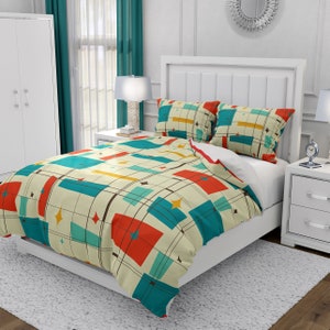 May include: A white bed with a geometric patterned duvet cover in shades of teal, orange, yellow, and brown. The duvet cover features a mid-century modern design.