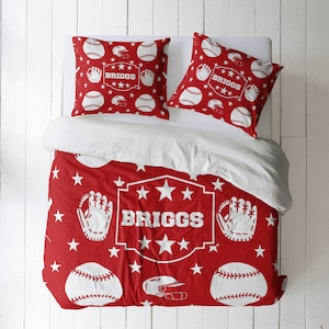 May include: Red and white baseball themed bedding set with a white star pattern and the name "BRIGGS" in a white banner. The set includes a duvet cover and two pillowcases.