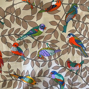 May include: A beige fabric with a repeating pattern of colorful birds on brown leafy branches. The birds are stylized and have different colors and patterns.