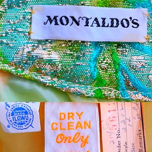 May include: A white label with the text "Montaldo's" on a green and blue fabric with a metallic sheen. A blue and white label with the text "Union Made ILGWU AFL-CIO Workers Union" and a yellow label with the text "Dry Clean Only" are also visible.