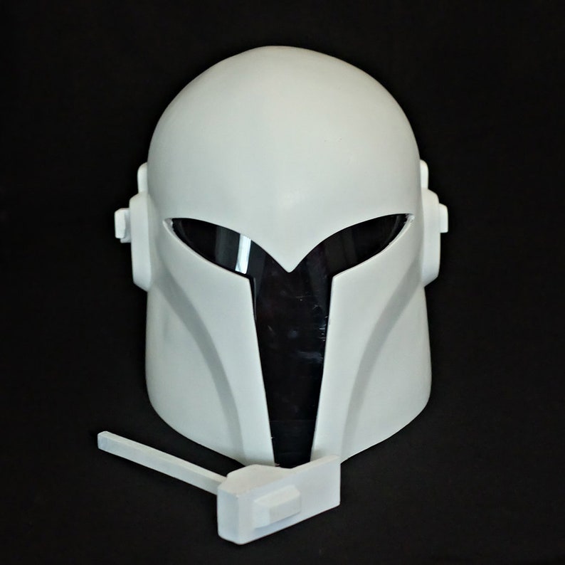 May include: White plastic helmet with a black visor and a white plastic accessory attached to the bottom.