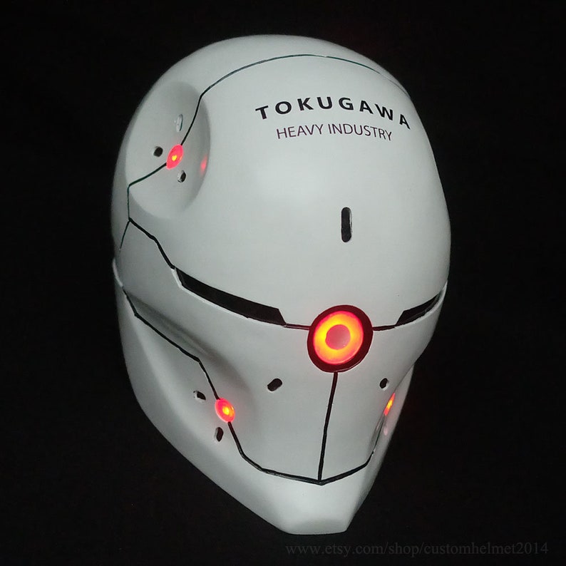 May include: A white helmet with red LED lights and the text "TOKUGAGAWA HEAVY INDUSTRY" on the top.