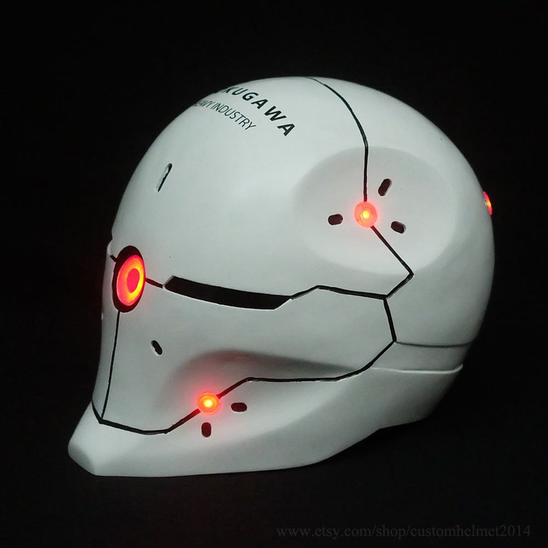 May include: White helmet with black accents and red LED lights. The helmet has the text "KUGUA WA INDUSTRY" on the side.