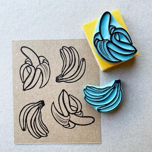 Banana hand carved rubber stamps, peeled banana and a banana bunch