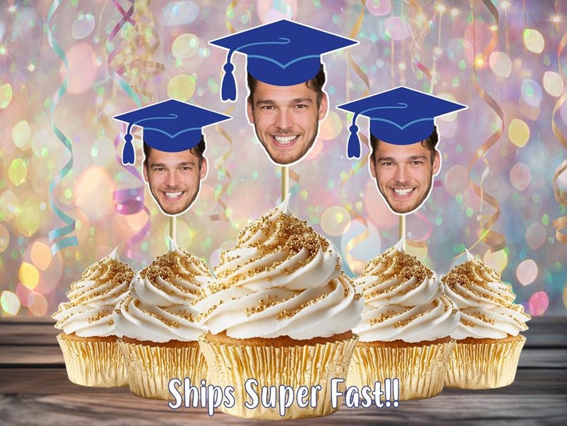 May include: Five cupcakes with white frosting and gold sprinkles, topped with graduation cap cutouts featuring a smiling face. The background has bokeh lights and streamers. Text at the bottom reads "Ships Super Fast!!"