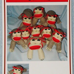May include: A sewing pattern for making a sock monkey, called "Admit One Fabrics Pattern". The pattern includes instructions for making an 8-inch frog sock monkey.