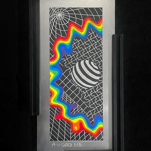 May include: Framed abstract art piece with a black and white geometric design, a rainbow-colored wavy line, and a striped sphere. The artwork is set in a silver frame with black borders. The text "AXURO LTD" is visible at the bottom.
