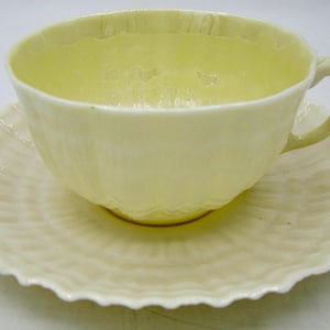 Belleek Limpet Yellow Flat Tea Cup and Saucer - 3rd Green Mark - Ireland