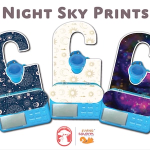 May include: Three blue plastic door hangers featuring different night sky designs. The designs include a celestial pattern with stars, moons, and planets, a white design with moons and suns, and a purple and blue galaxy design. Each hanger has a hook at the top and a small blue plastic cup at the bottom.