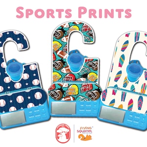 May include: Three blue and white door hangers with a sports theme. The hangers have a hook at the top and a small cup at the bottom. The hangers are decorated with baseballs, footballs, and surfboards. The hangers are labeled "Stronger Trees" and "Flying Squirrel".