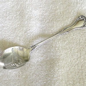 May include: Silver souvenir spoon with an image of a church and the text "St. John's Church, Greenfield, Mass." on the bowl.