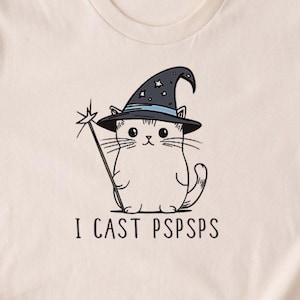 An illustration of a cat wearing a black wizard hat, holding a staff with the text I cast pspsps underneath