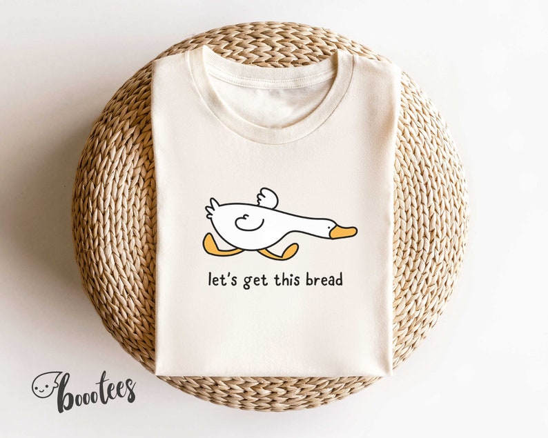 A funny duck shirt that says let's get this bread.