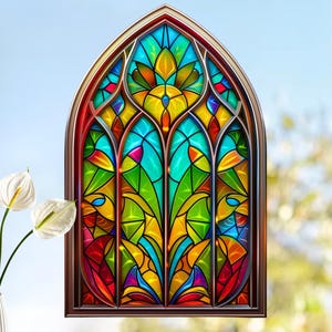 May include: A decorative stained glass window with a brown frame. The window features a vibrant design with shades of red, yellow, green, and blue. The design is symmetrical and floral-inspired, with a clear blue sky in the background.