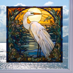 May include: A stained glass window design featuring a white egret standing in a marsh with a yellow sun in the background.