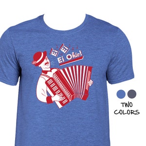 May include: A blue t-shirt with a red and white illustration of a man playing an accordion. The illustration includes the text "Ei Ohio!"
