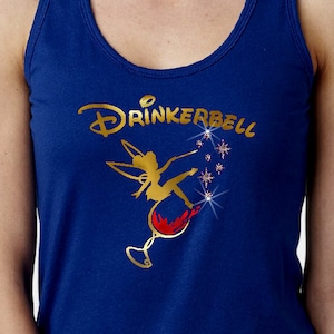 May include: A royal blue tank top with a gold graphic of a fairy sitting on a wine glass. The graphic says "Drinkerbell" in gold lettering.