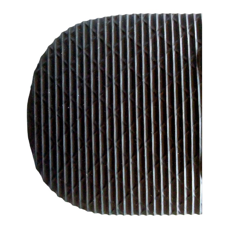 May include: Close-up of a black rubber sole with a textured pattern of raised lines and diamonds.