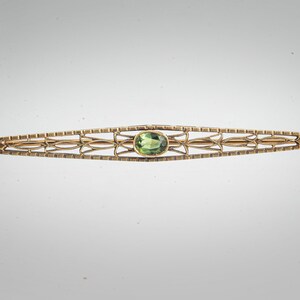 Arts & Crafts 14k peridot bar pin