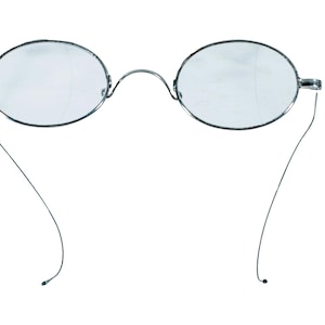 May include: Oval-shaped eyeglasses featuring thin, silver-toned metal frames and clear lenses. The spectacles include a delicate, arched bridge connecting the two rims and slender, wire-like temples that curve downward at the ends.