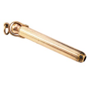 May include: A gold-colored, cylindrical pencil holder with a textured, ridged design. The pencil holder has a loop at the top for attachment and a dark spot near the tip. The pencil holder is approximately 4 inches long.