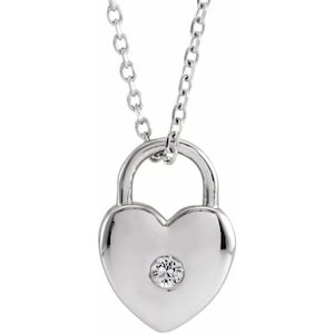 May include: A silver heart-shaped padlock necklace with a small clear diamond in the center.