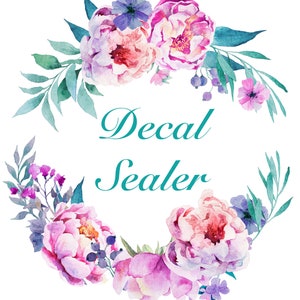 May include: Watercolor floral wreath with pink and purple flowers and green leaves. The text "Decal Sealer" is written in the center of the wreath.
