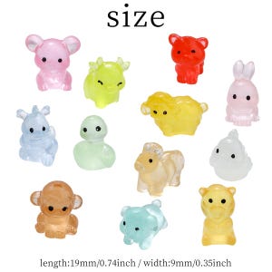 May include: A collection of translucent animal figurines in various colors, including pink, red, yellow, blue, and green. The figurines include a bear, rabbit, sheep, monkey, and other animals. The text "size" is at the top. The length is 0.74 inches and the width is 0.35 inches.