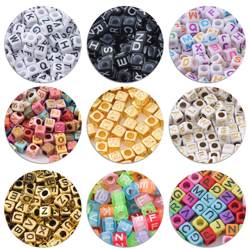 May include: Assortment of letter beads in various colors and materials.  The beads are square shaped with letters printed on each side.  The colors include white, black, gold, multi-colored, and translucent.
