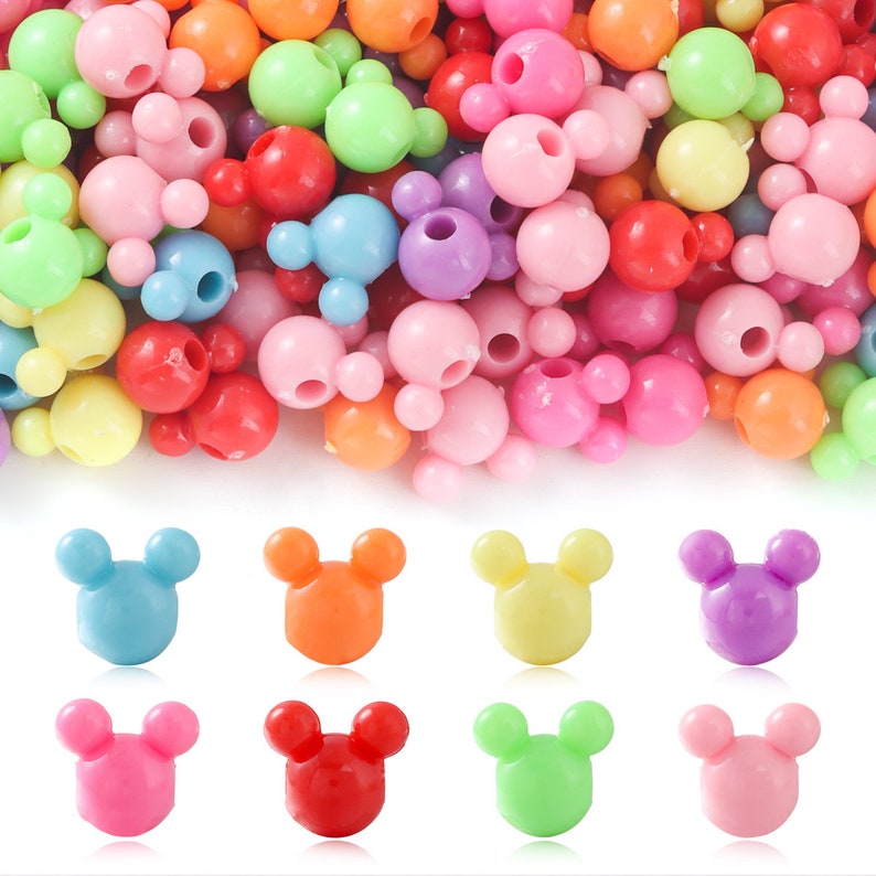 May include: Assortment of colorful plastic beads with a Mickey Mouse head design. The beads are in various colors, including pink, blue, green, yellow, orange, and purple.