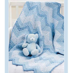 May include: A blue and white crocheted baby blanket with a blue teddy bear sitting on top of it.