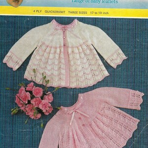 May include: A knitting pattern for a baby cardigan and dress. The pattern is for sizes 17 to 19 inches and uses 4 ply quick knit yarn. The cardigan is white with pink trim and the dress is pink.
