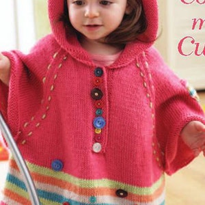 May include: A pink knitted hooded poncho with colorful buttons down the front and a striped bottom. The poncho has a yellow, green, blue, and white striped bottom with colorful buttons.