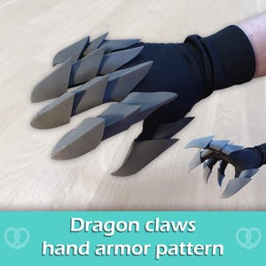 May include: A black glove featuring articulated grey foam dragon claws attached to the fingers and thumb. The design includes layered, pointed segments that extend from the knuckles to the fingertips, creating a clawed appearance for the hand.