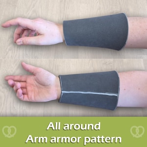 May include: A dark gray arm guard featuring a smooth, matte texture that wraps around the forearm. The piece includes a visible seam running along the length of the arm. The text "All around Arm armor pattern" is displayed at the bottom.