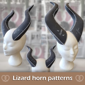 May include: Three white mannequin heads displaying dark grey foam lizard horn patterns. The foam pieces feature white printed markings, lines, and the text 1 LIZARD L or 1 LIZARD S. The horns are curved and pointed, designed as templates for crafting.