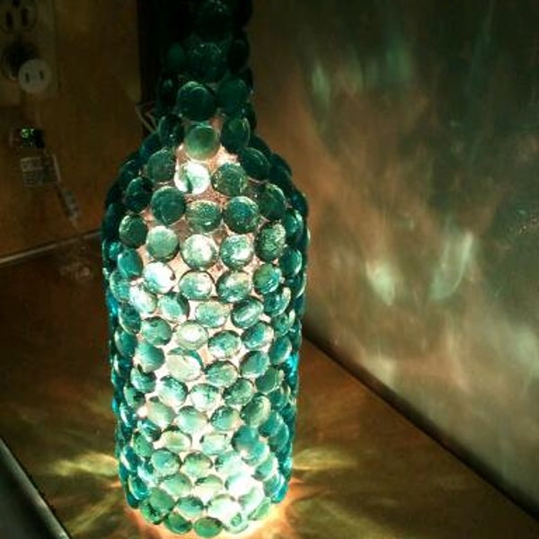 Blue glass rock lighted wine bottle
