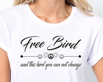 May include: White t-shirt with the text "Free Bird" and "and this bird you can not change" printed on it. The text is in black and there are three symbols above the line: a smiley face, a peace sign, and another smiley face.