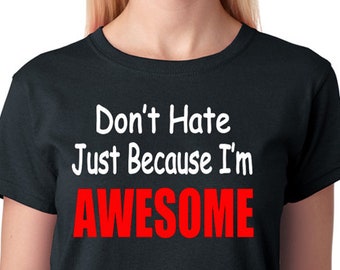 May include: Black t-shirt with white text that reads "Don't Hate Just Because I'm AWESOME" with the word "AWESOME" in red.