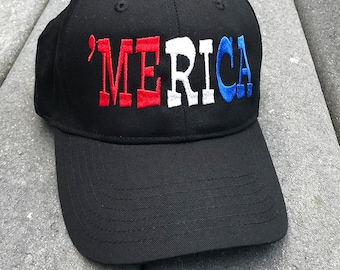 May include: A black baseball cap with the word "'MERICA" embroidered in red, white, and blue.