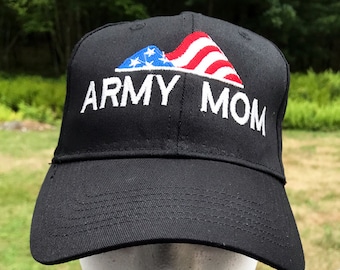 May include: Black baseball cap with a white embroidered American flag and the text "ARMY MOM".
