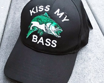 May include: Black baseball cap with a green and white embroidered bass fish and the text "Kiss My Bass".