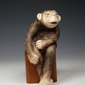 Ceramic Chimp sculpture, unique taupe and brown ceramic chimp sitting on wood