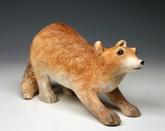 Ceramic fox sculpture, playful and animated, tan and brown realistic fired clay fox figurine