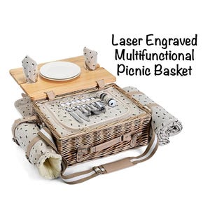 May include: A laser-engraved, multifunctional picnic basket made of woven wicker. The basket includes a wooden lid, plates, cutlery, napkins, and a blanket. The text on the image reads: "Laser Engraved Multifunctional Picnic Basket."