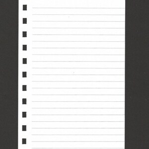 May include: A rectangular white sheet of paper with horizontal lines and a vertical column of square punch holes along the left edge. The paper is set against a solid black background, creating a high contrast visual display.