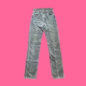 May include: A pair of gray denim jeans with a high waist and straight leg. The jeans have a classic five-pocket design, a button and zipper closure, and belt loops. The jeans are displayed against a bright pink background.